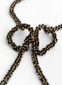 Bow Necklace Black and Gold Beatriz Palacios Close up Shot