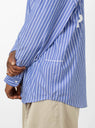 pop trading logo striped shirt on model up close 