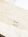 The Base Field Tote (L) from This is (an) arrives in White at Couverture & The Garbstore
label