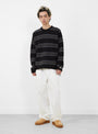The Striped Wool Sweater from Stüssy comes in Black at Couverture & The Garbstore 
model front