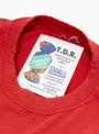 The American Waste T-Shirt from TDR comes in Red at Couverture & The Garbstore
label