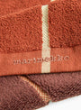 Tiiliskivi Hand Towel Chestnut Marimekko (logo detail) at Couverture & The Garbstore